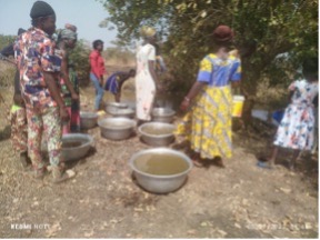 Women collecting water before the borehole