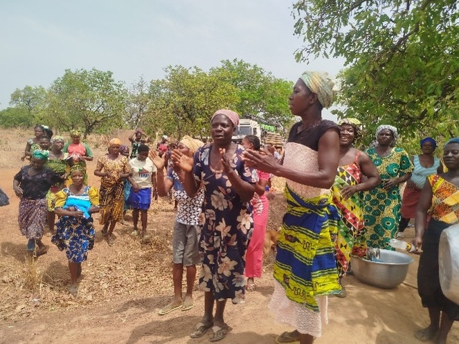 The community celebrate as the borehole is completed