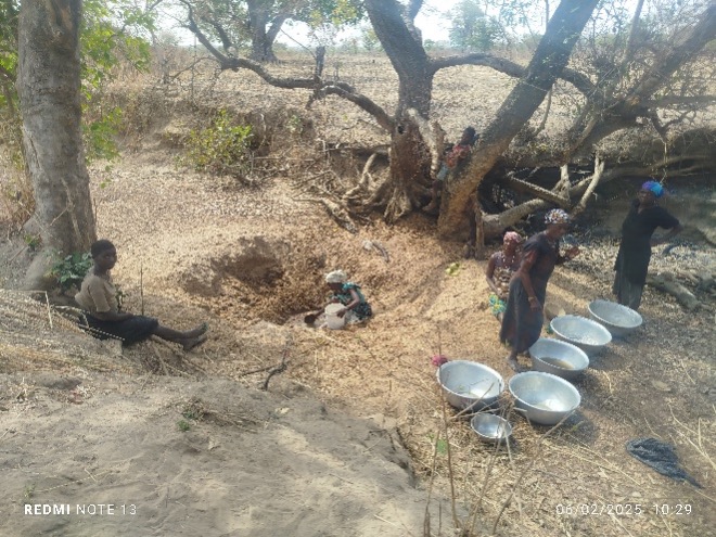Community members digging for water